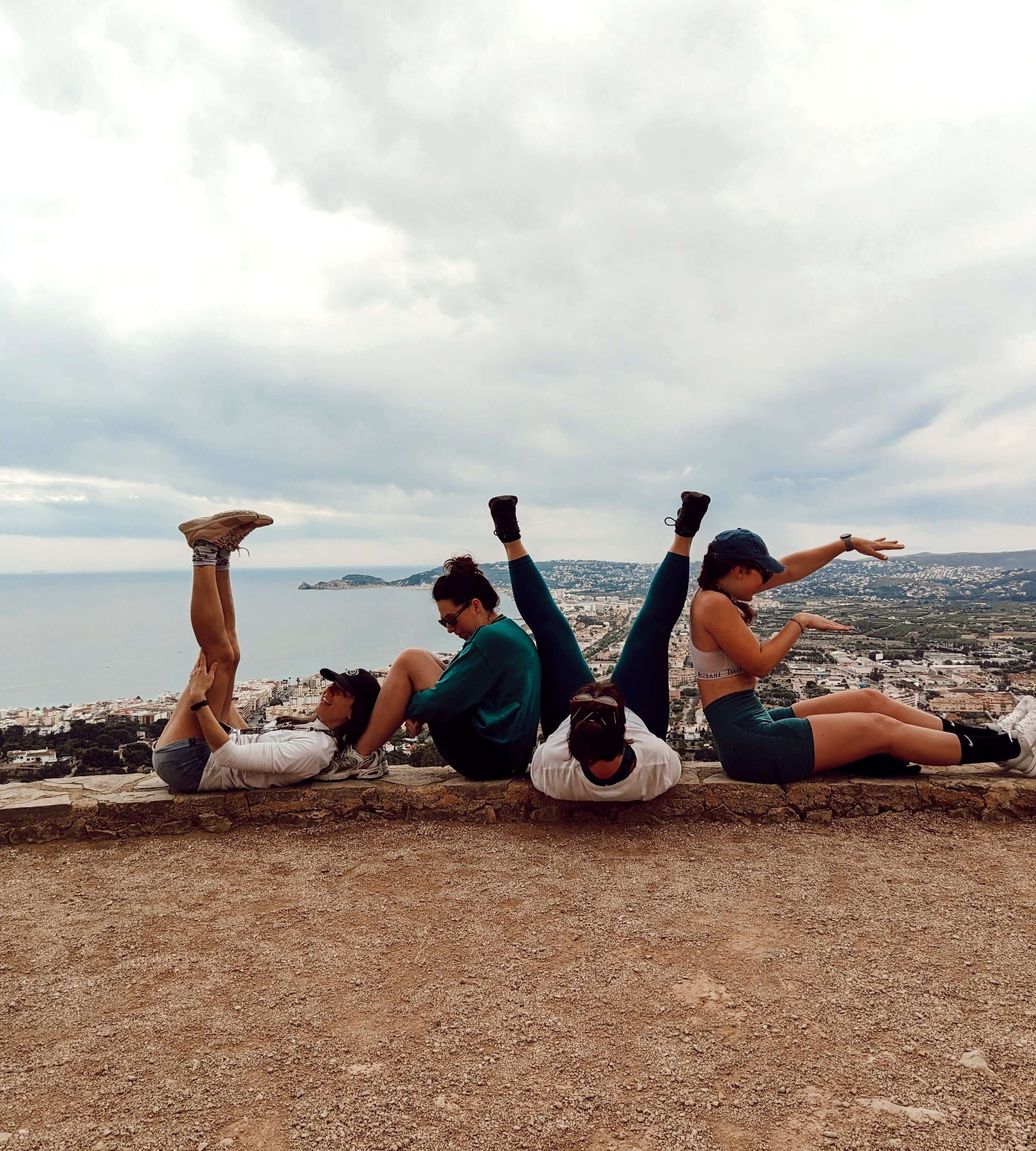4 friends spelling out the word Love while overlooking Spain