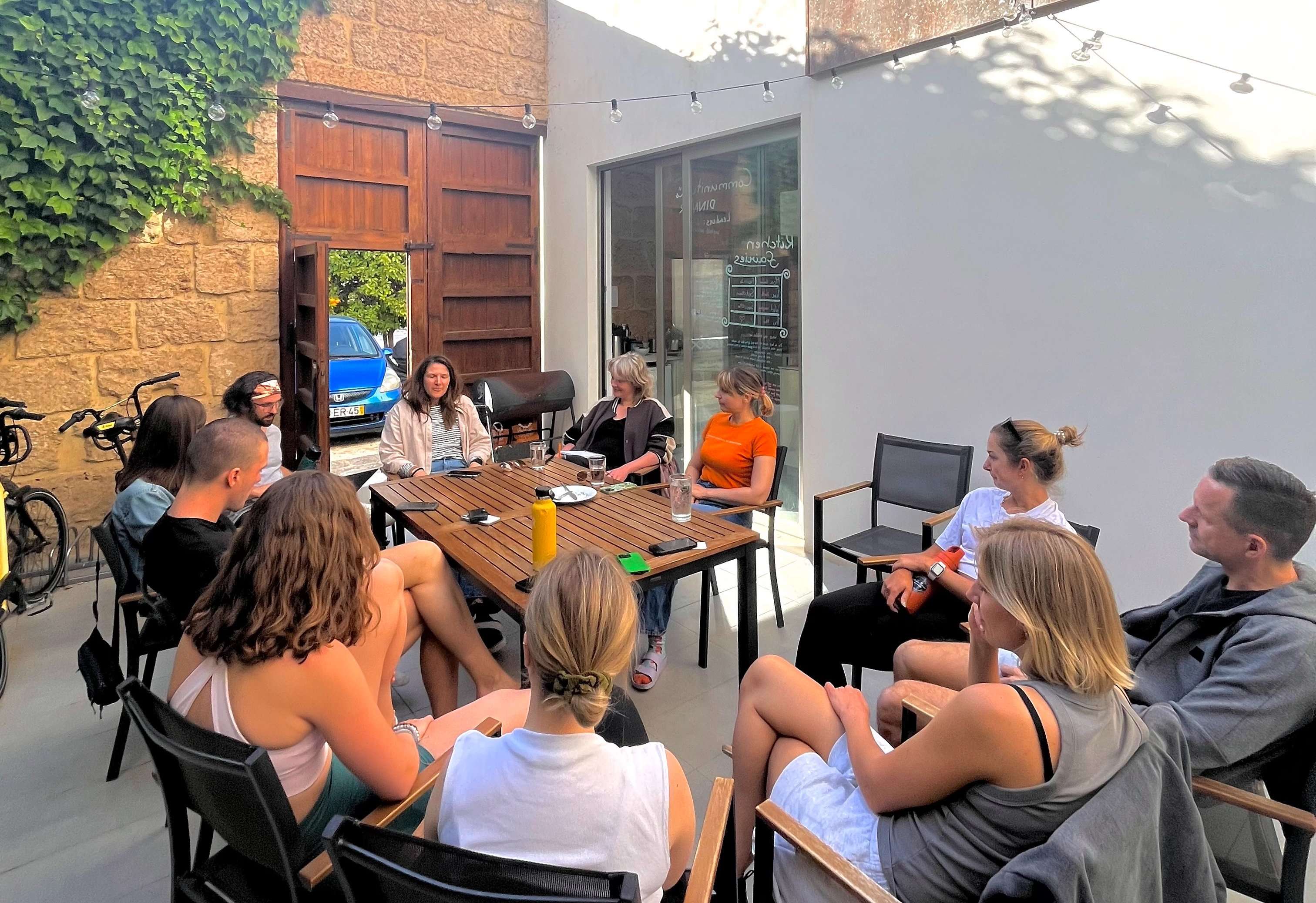 A group of people at Sun & Co sitting outside coming up with a solution to someone's problem.