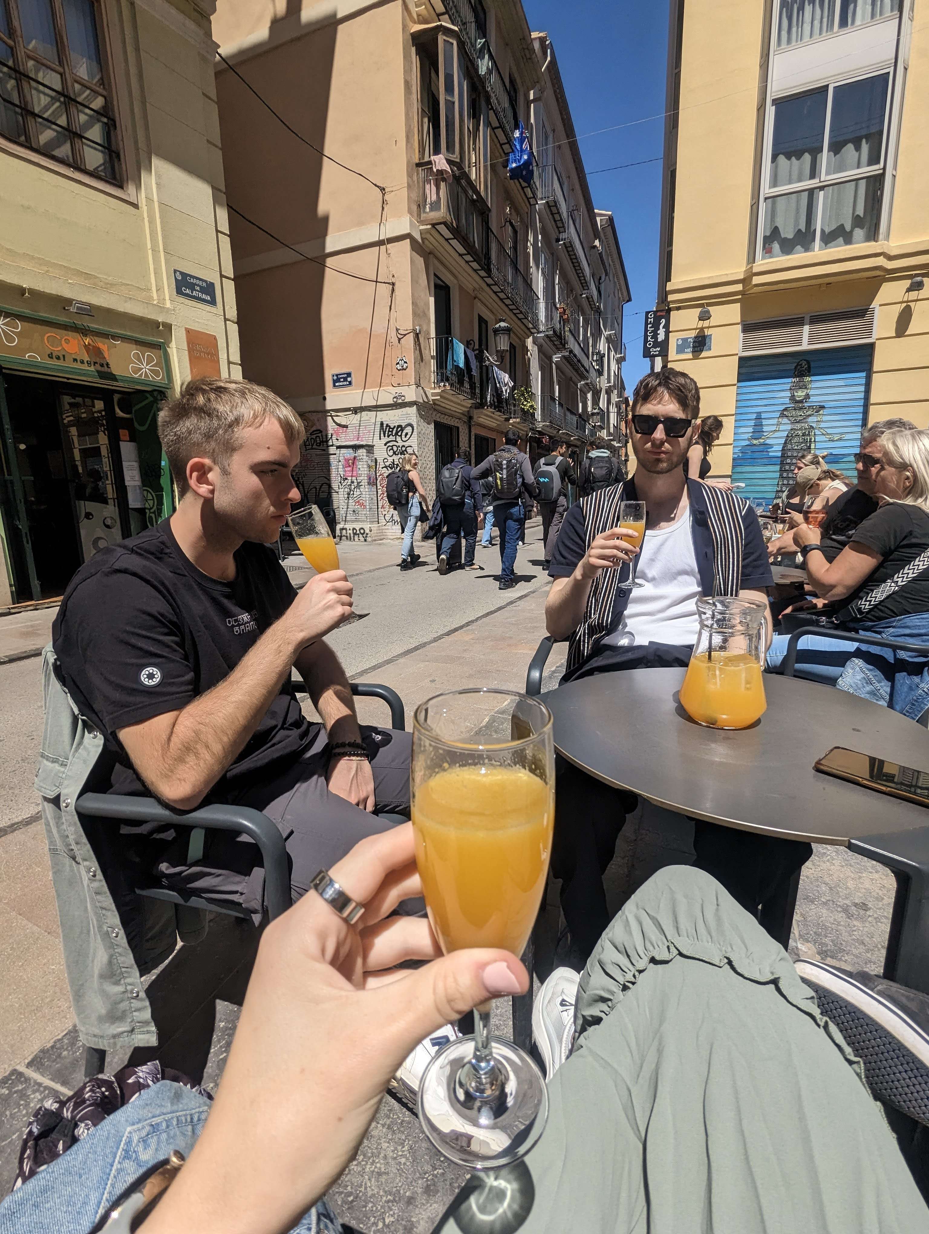 A few friends drinking Aqua de Valencia in the street in Valencia.