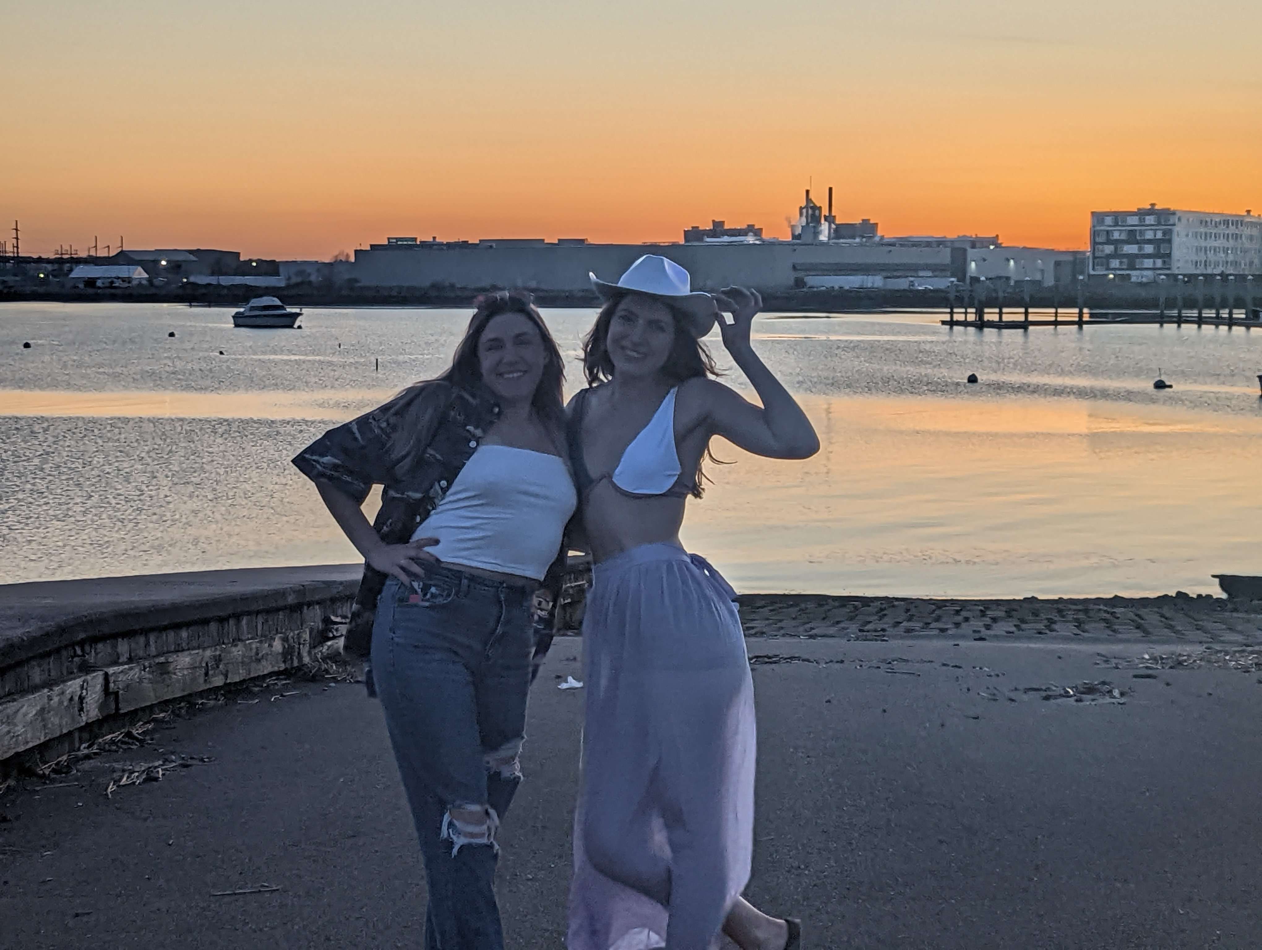 My friend and I (Traveler Liz) posing in front of the ocean, Boston Skyline, and Sunset on the Nahant Causeway.