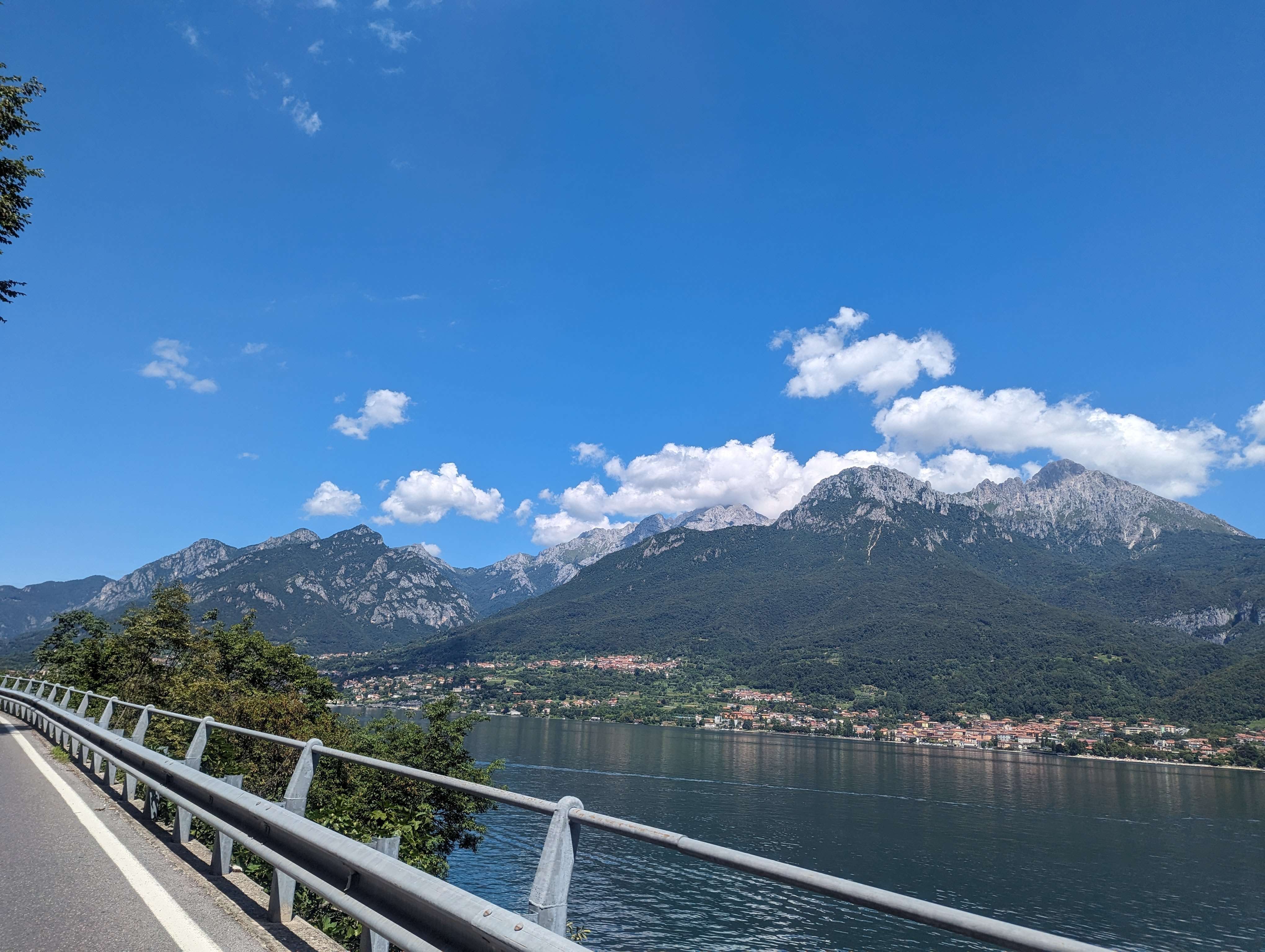 The drive along the water next to Lake Como in Italy with a beautiful view of the Swiss Mountains in the distance.