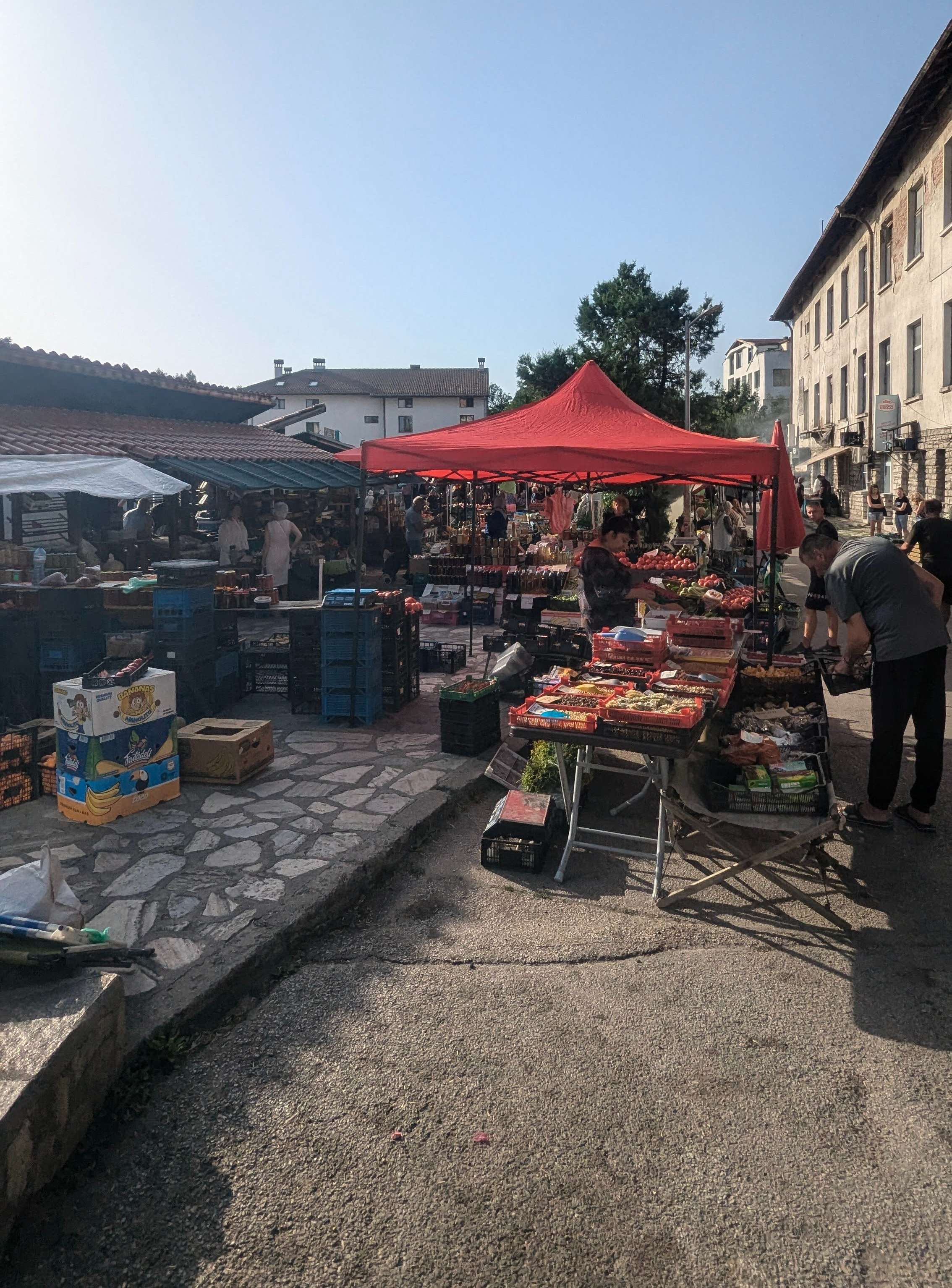 The farmers market in Bulgaria that is full of people and food.