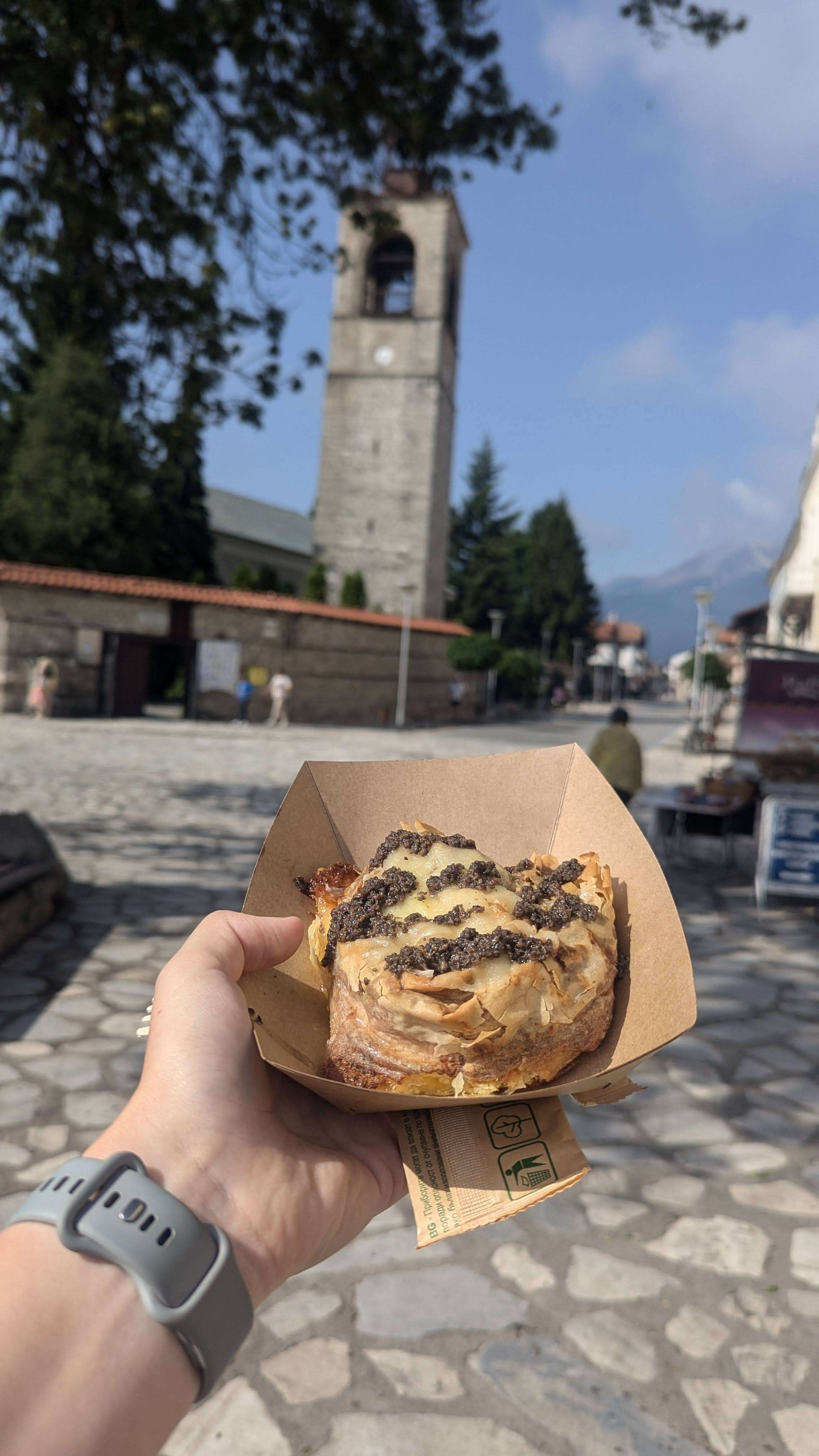 A picture of a delicious benitsa, which is a flaky pastry with cheese and truffles on top.