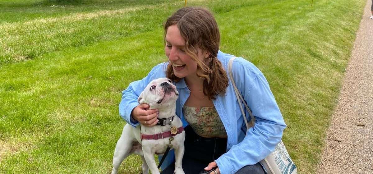 Me (Budget Traveler Liz) sharing a playful moment with my housesitting companion, a French Bulldog, in London.