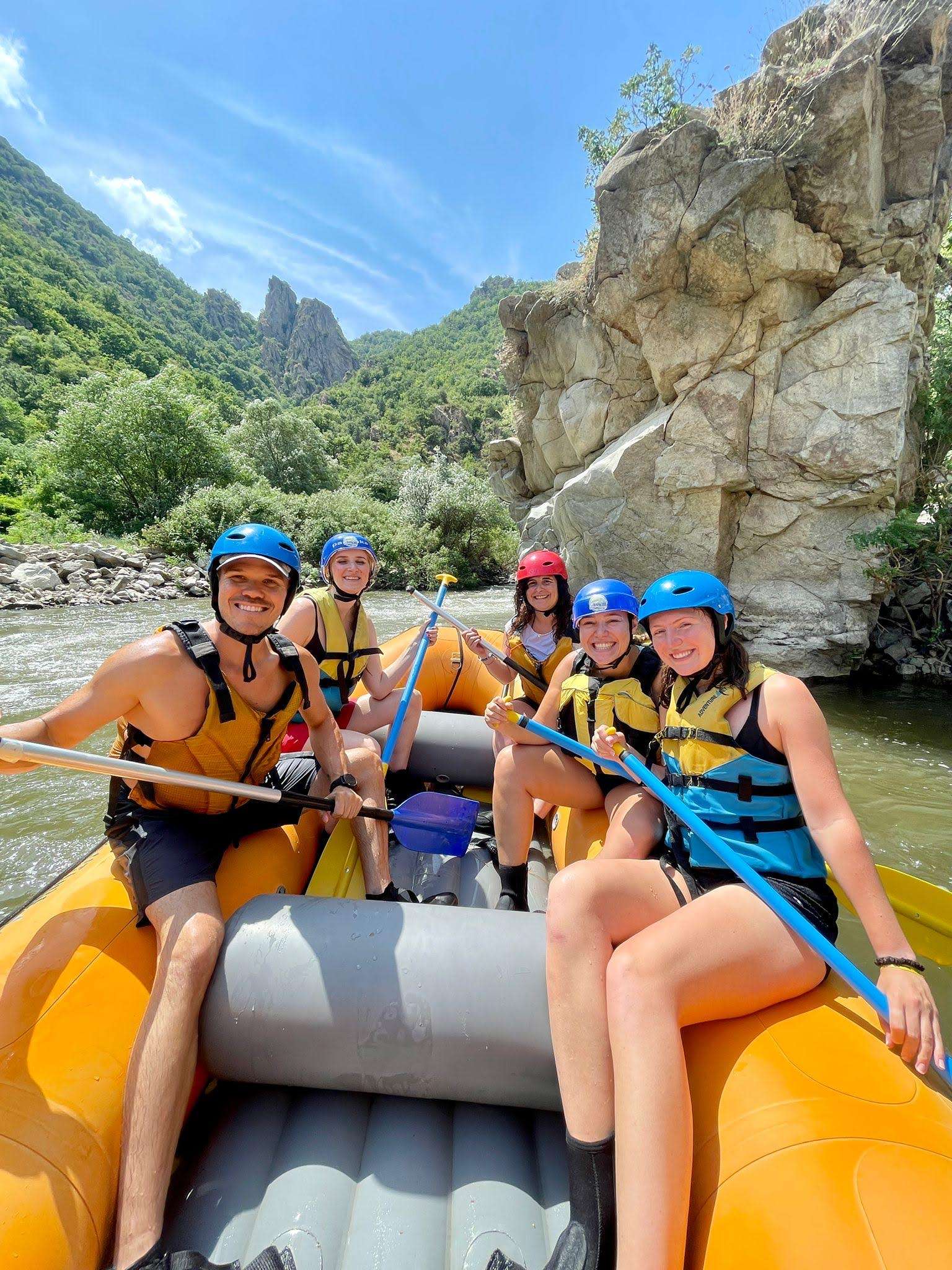 5 friends in a rafting boat on the river in Bulgaria
