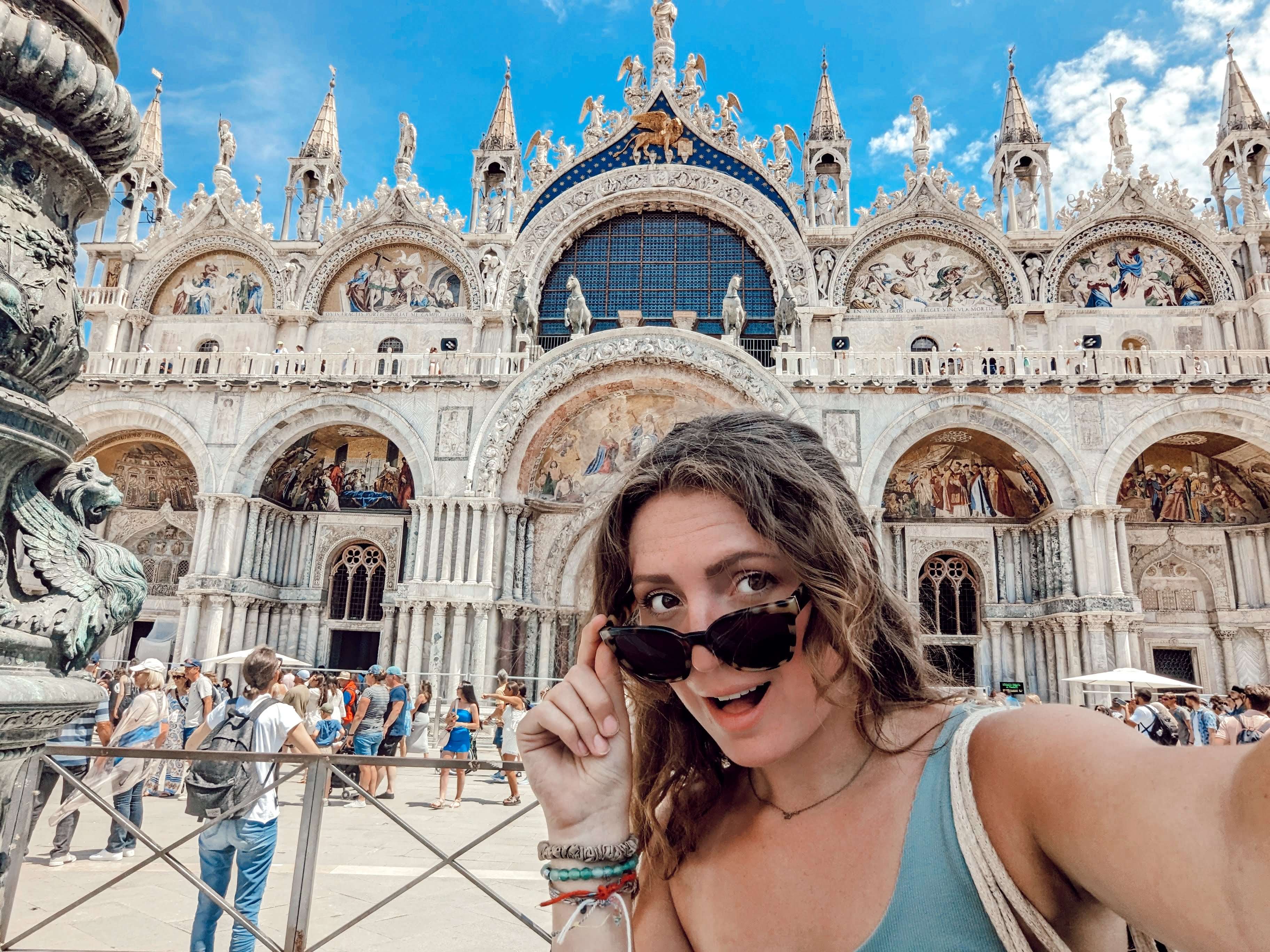 Me (Traveler Liz) standing in front of St. Mark's Basilica.