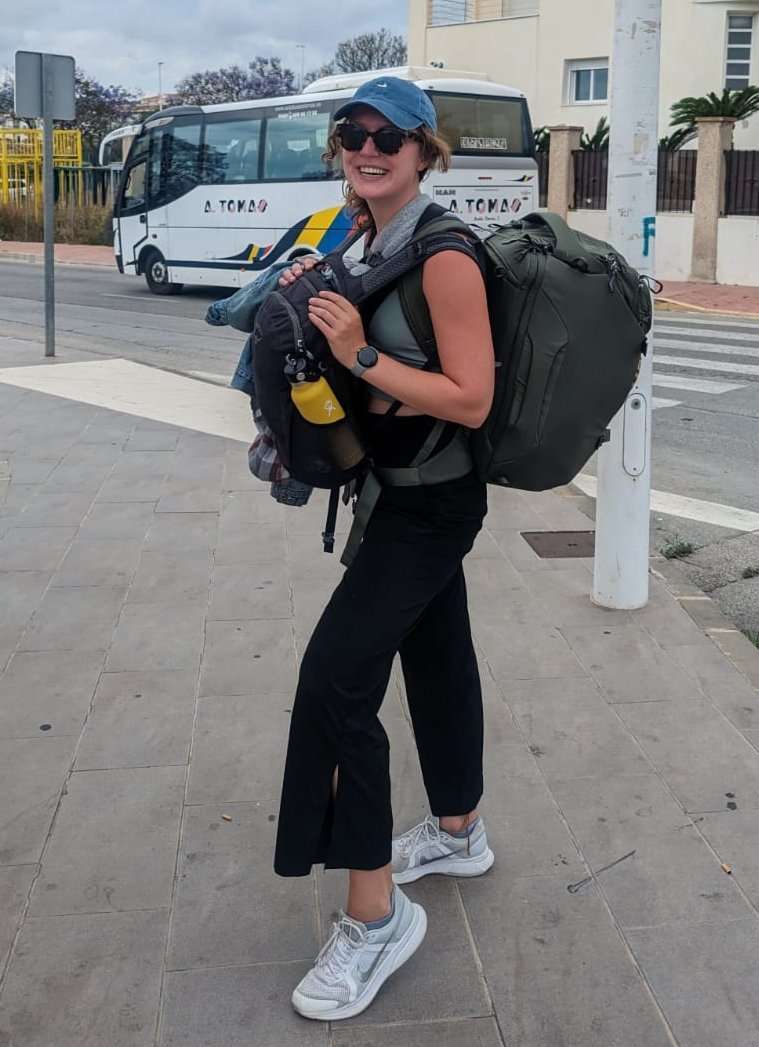 Traveler Liz with her two backpacks while leaving a coliving in Spain
