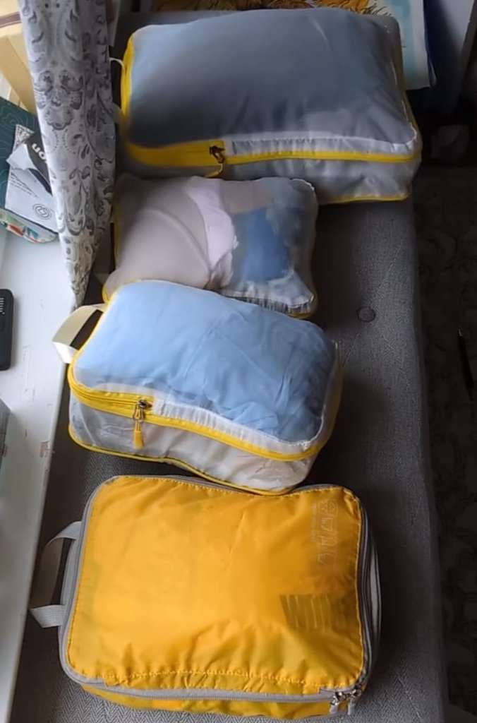 4 see-through compression bags with yellow accents.
