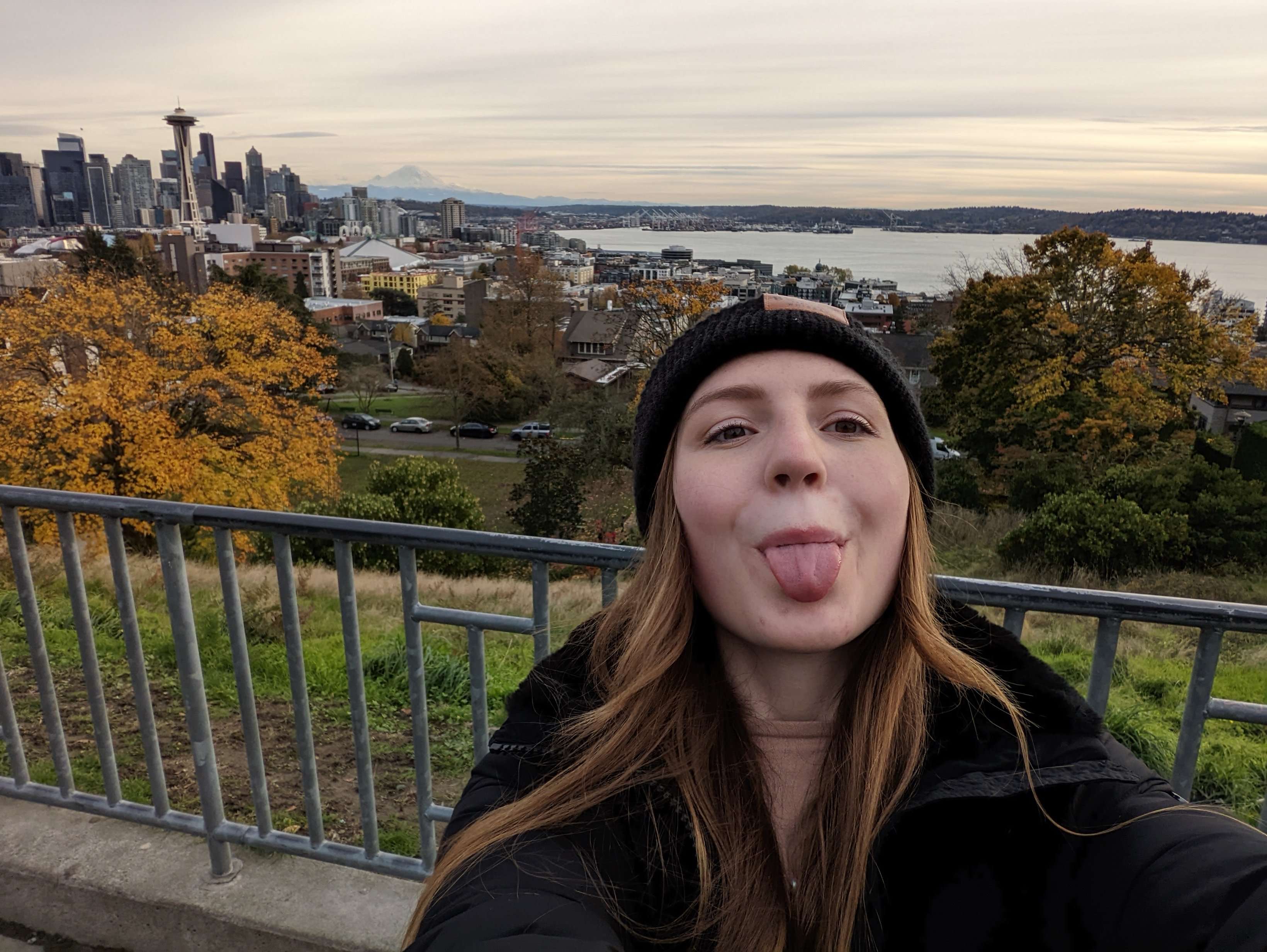 Me (Traveler Liz) taking a selfie in Kerry Park with the Seattle Skyline behind me.