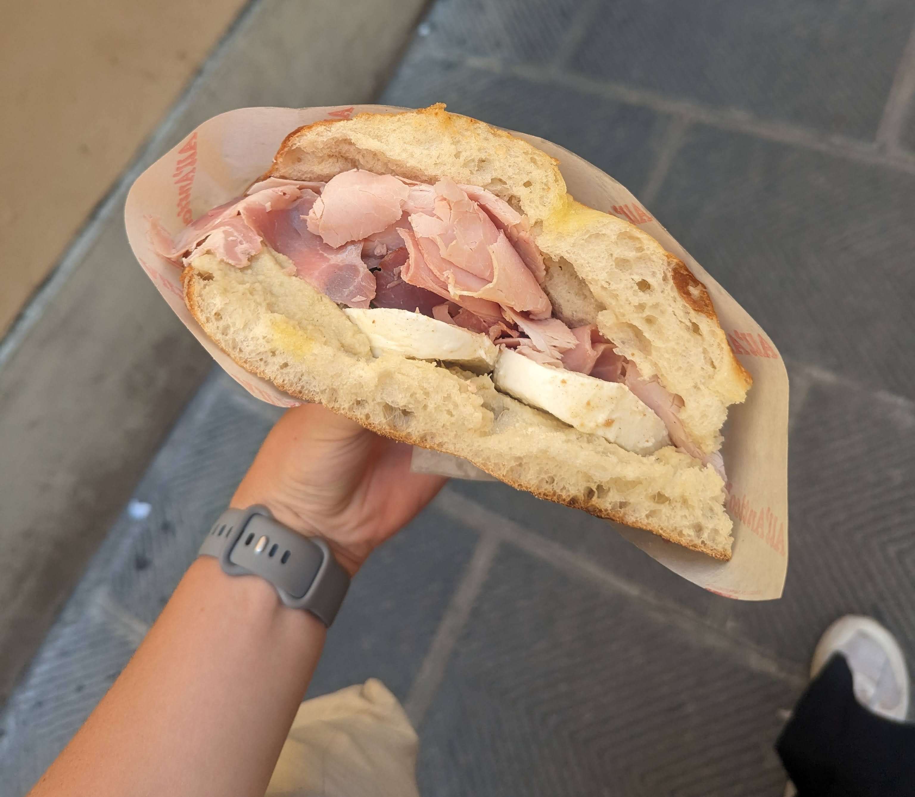 A huge sandwich from the famous shop with meat and cheese in Florence