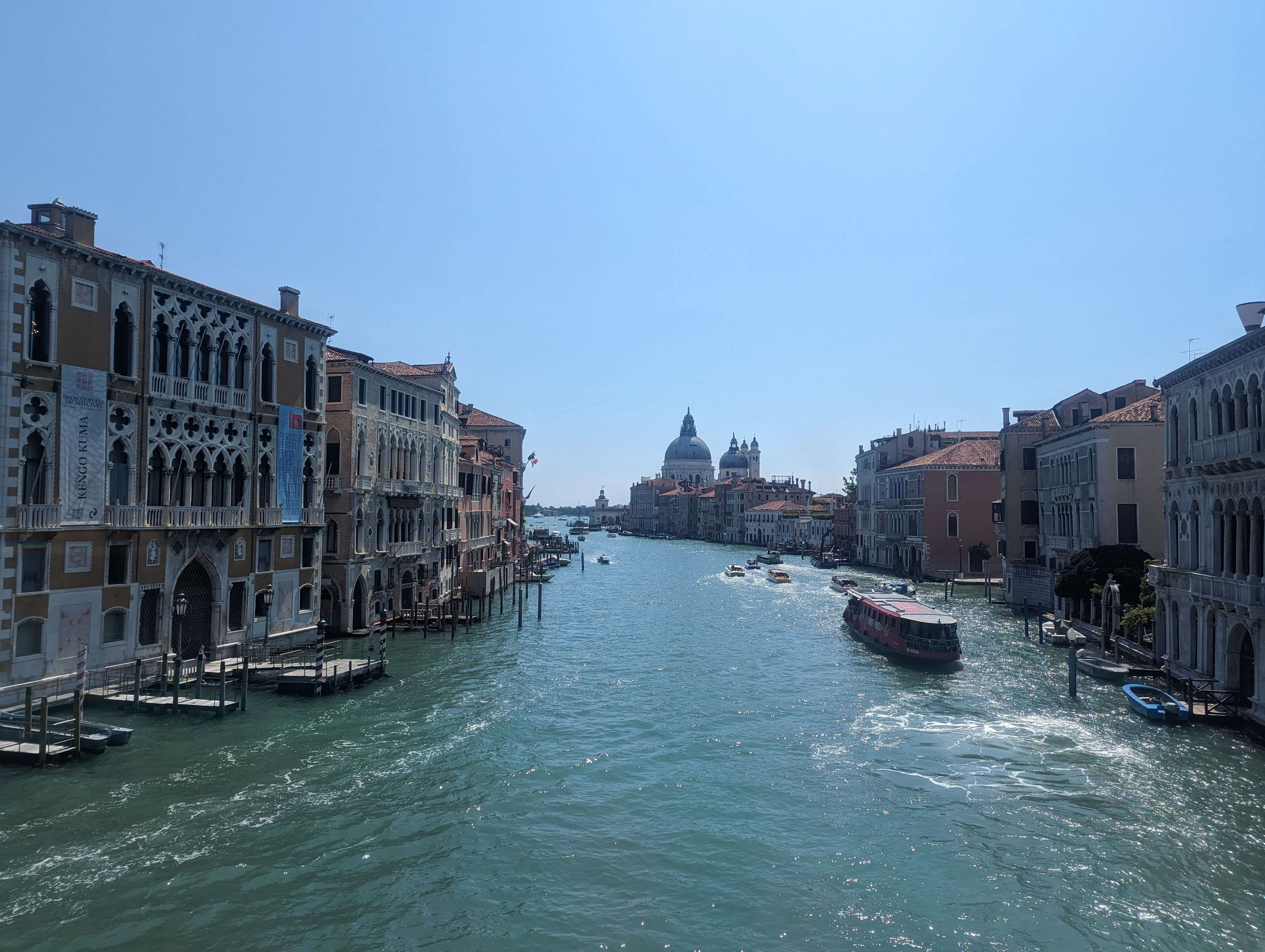 The Grand Canal with boats going down it and beautiful buildings lining the sides.