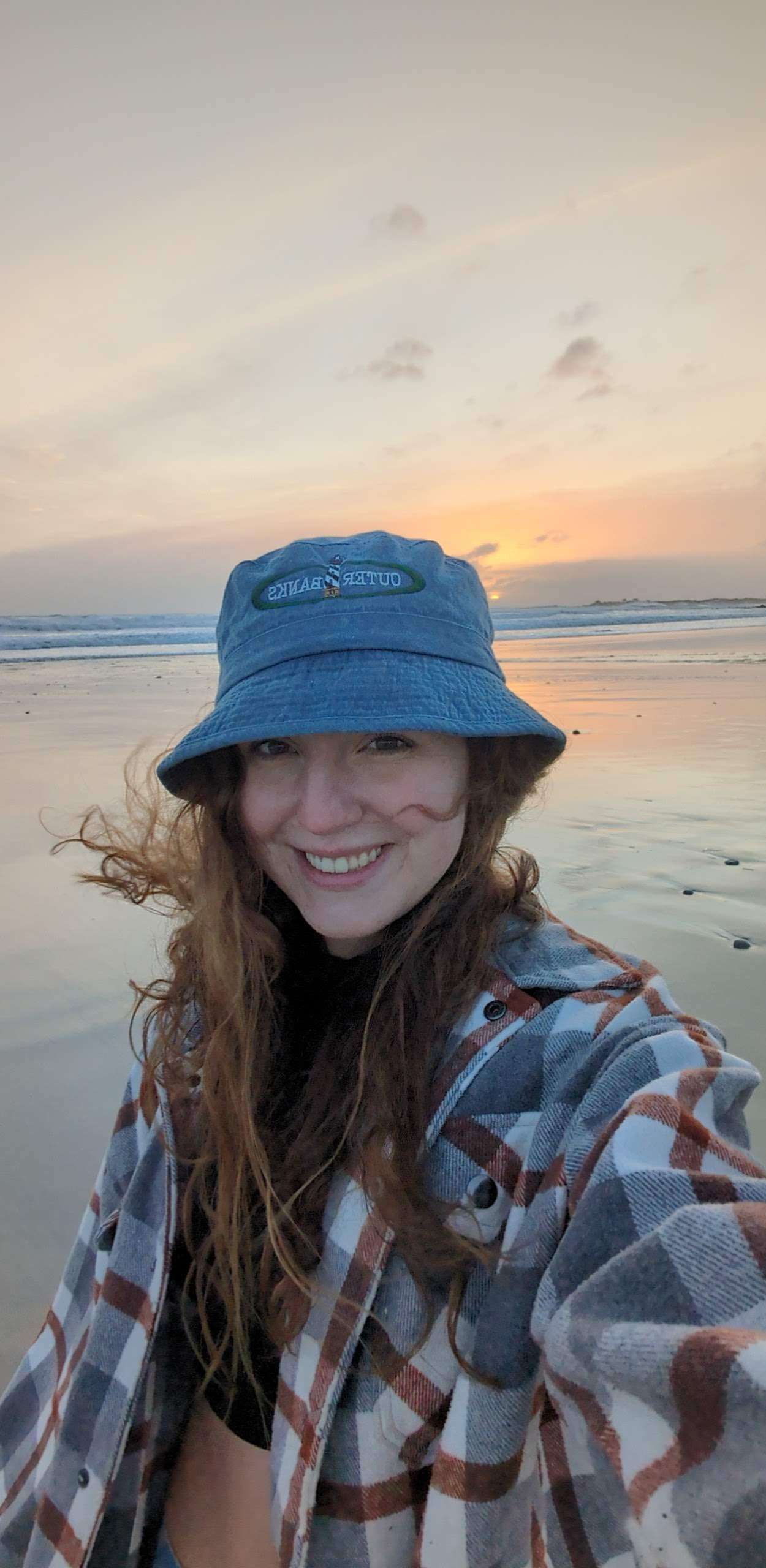 Traveler Liz on the beach in Monterey