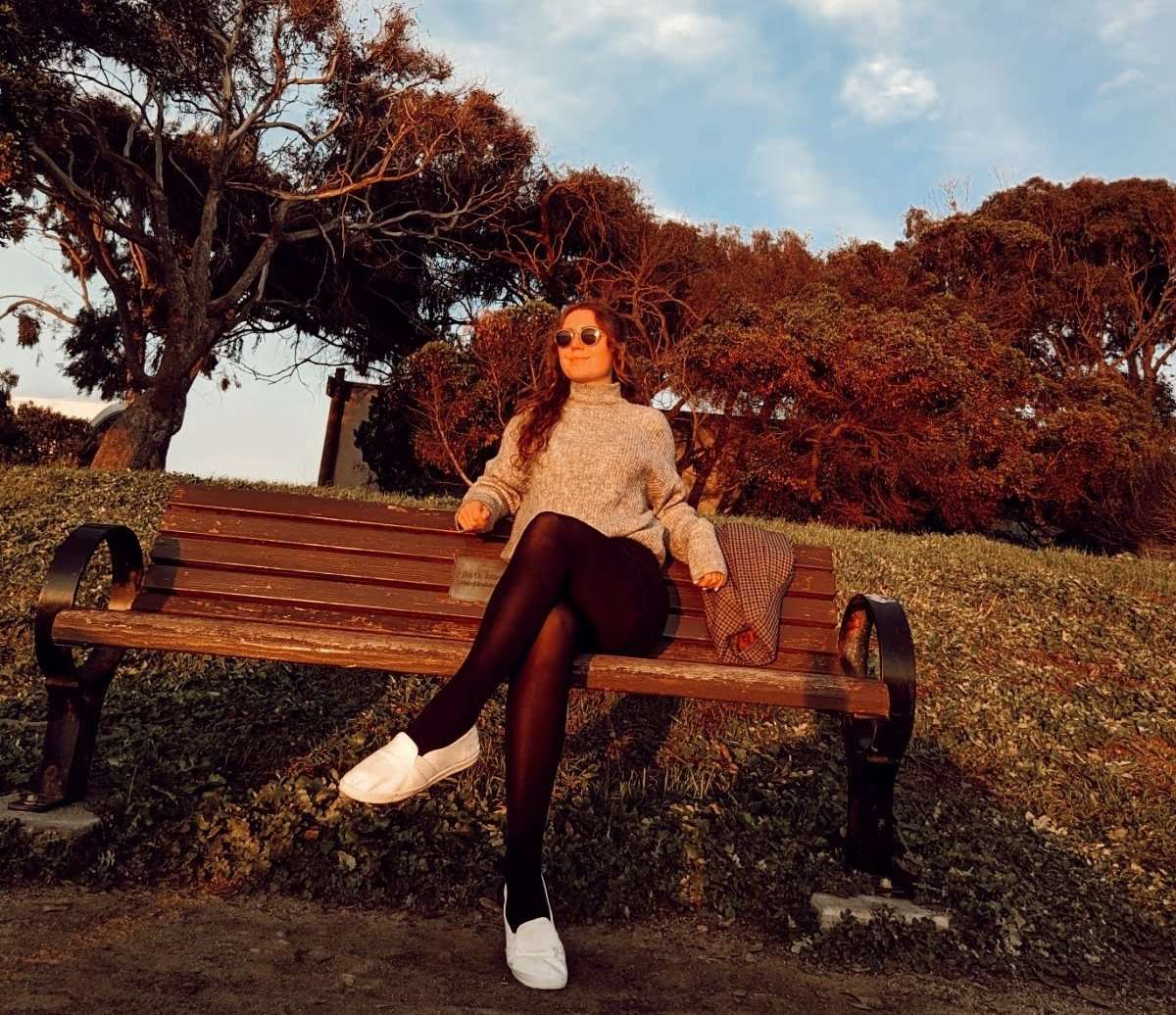 Me (Traveler Liz) sitting on a bench and people watching.