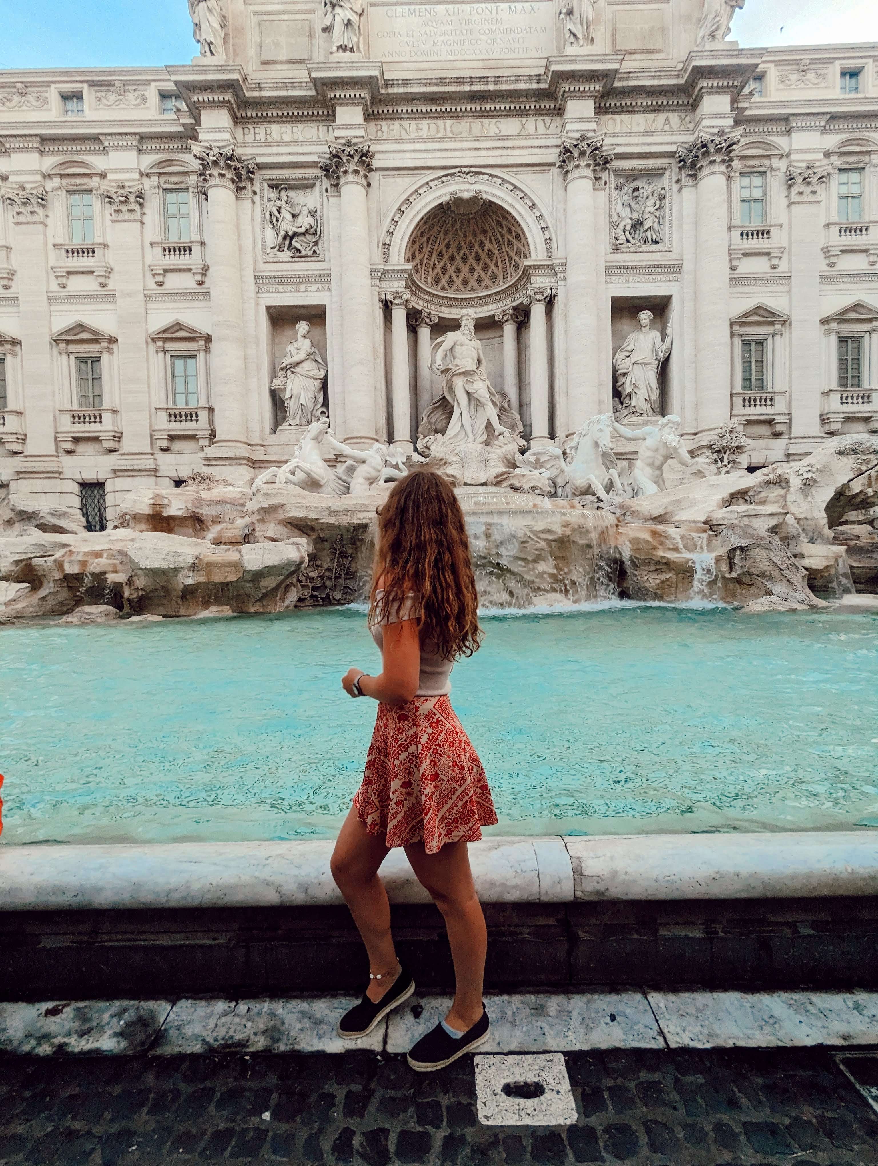 Traveler Liz pictured in front of the Trevi Fountain in Rome