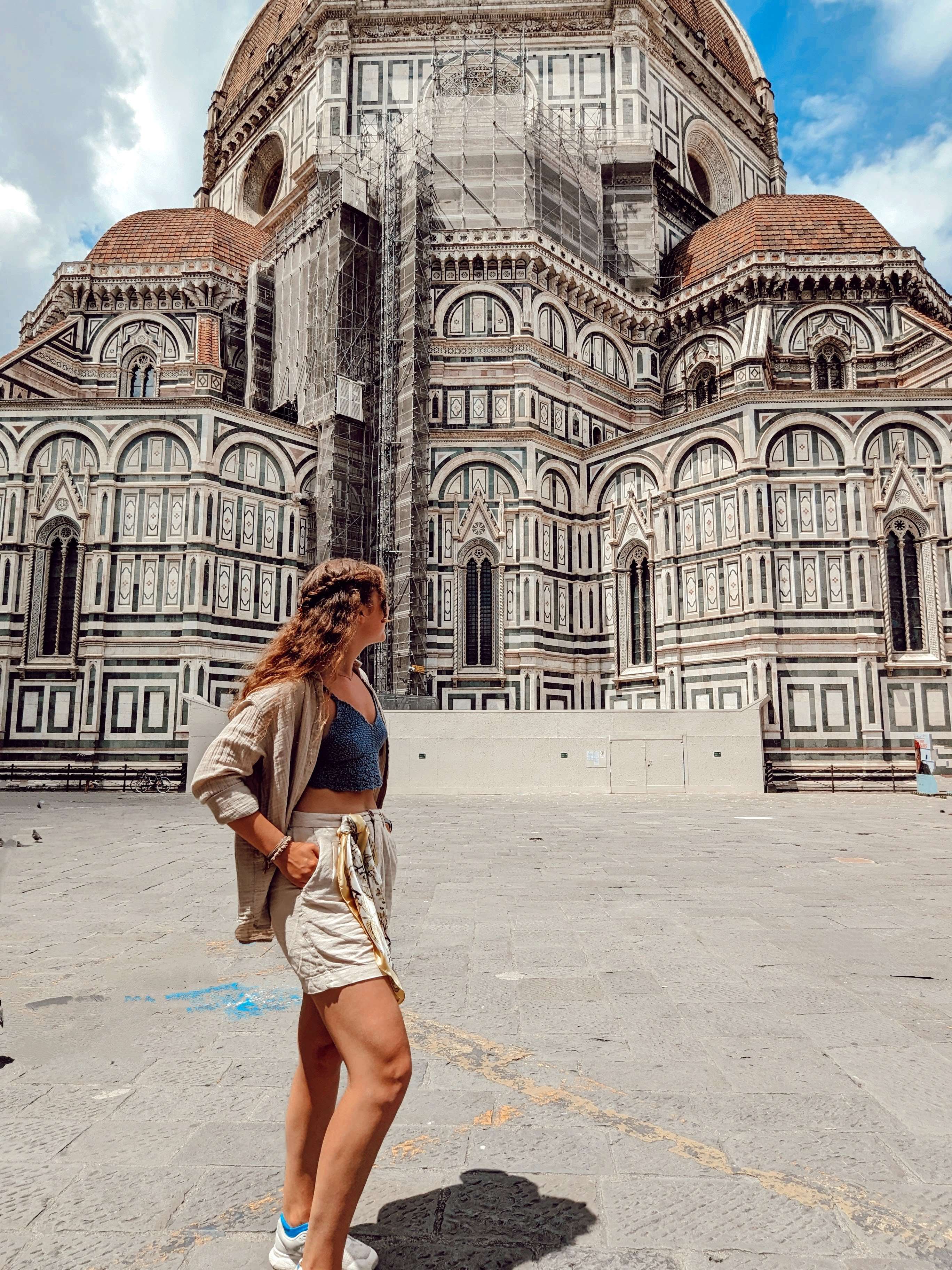 Traveler Liz pictured in front of the Duomo.