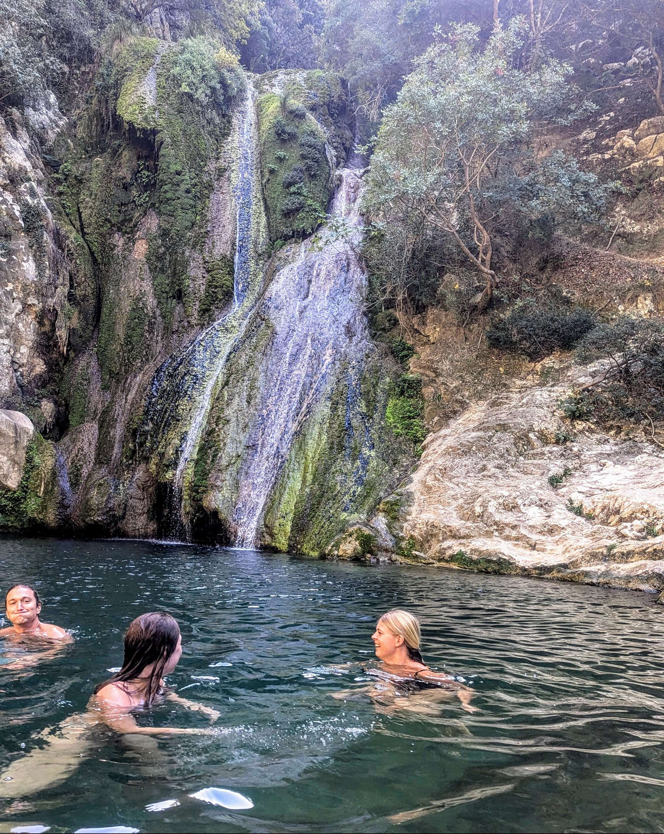 Traveler Liz and a few others swimming in the waterfall