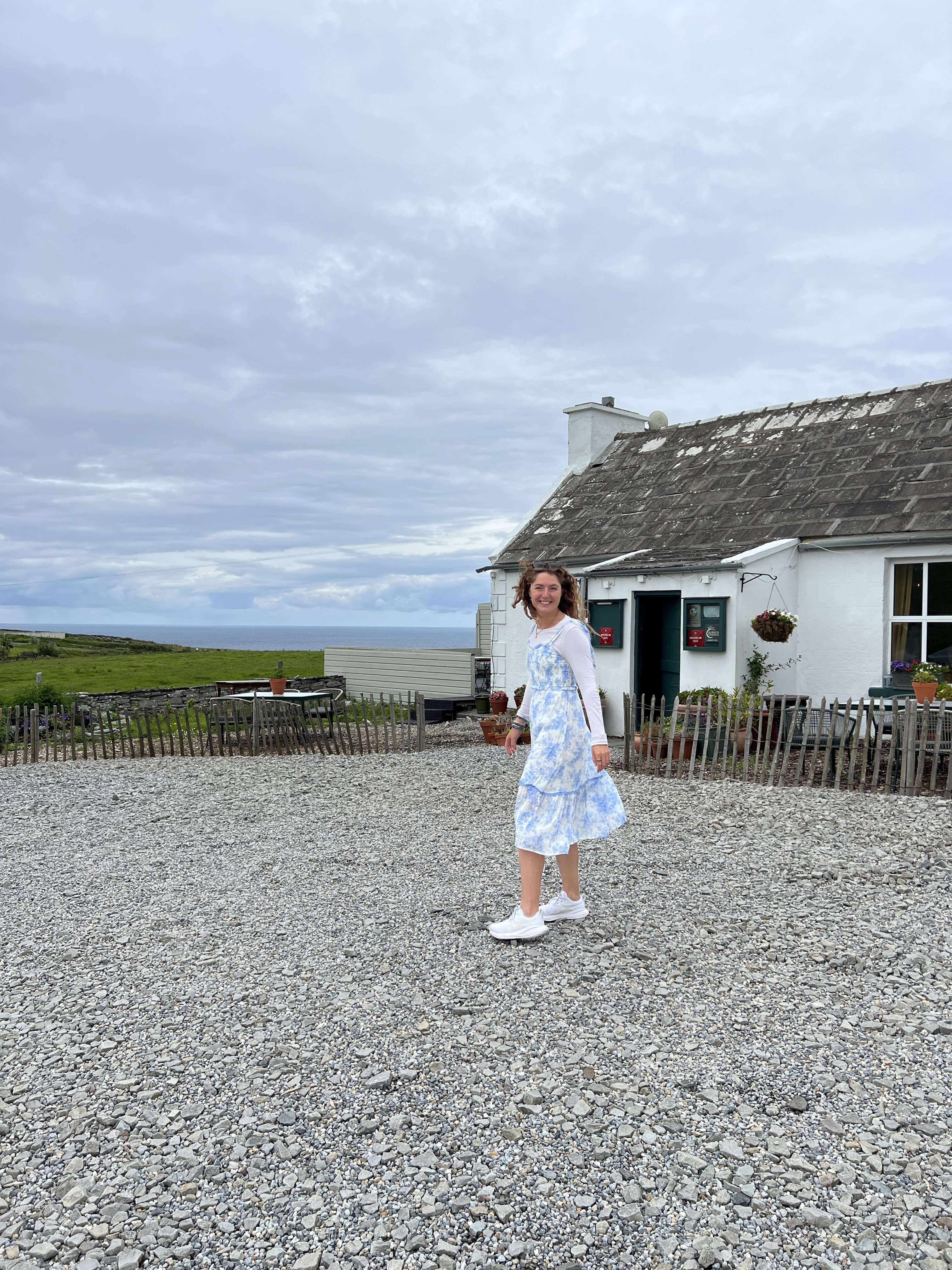Liz standing outside Homestead Cottage, a Michelin guide restaurant in Ireland.