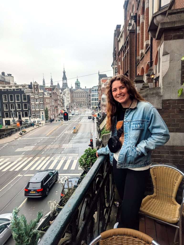 Liz standing on the balcony of a hotel in downtown Amsterdam