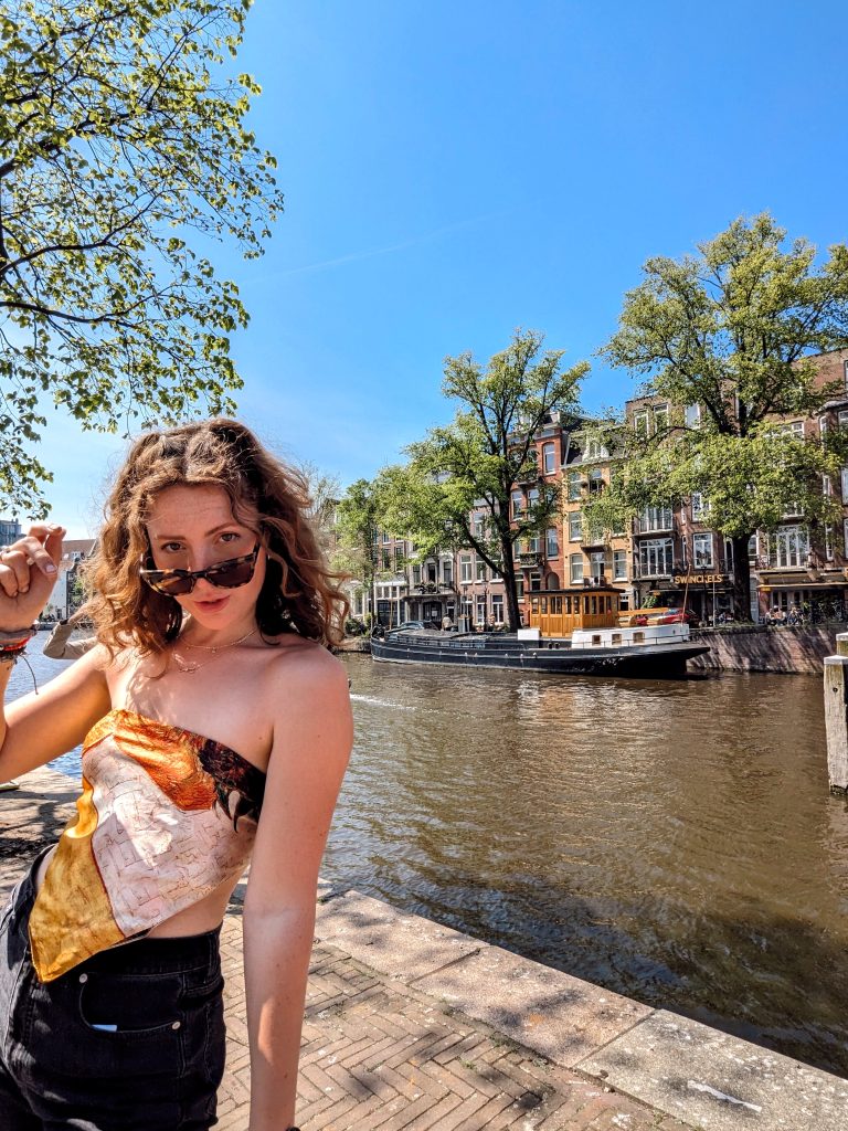 Liz standing in front of the canal boats in Amsterdam