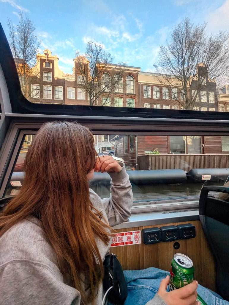 Traveler Liz looking at all the dutch houses while sitting in a canal boat