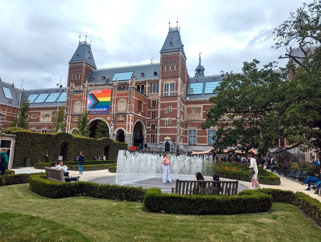 The Rijksmuseum and its garden standing tall on a cloudy day in Amsterdam