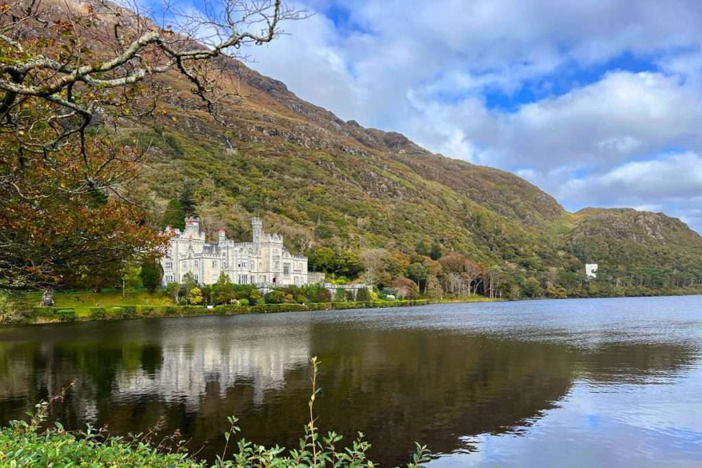 Beautiful Kylemore Abbey in Ireland with the building reflecting off of the lake.