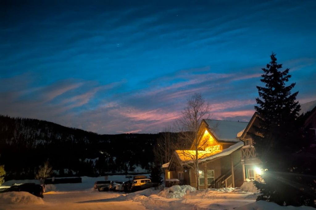 A cute cottage at night in Breckenridge with the sunset