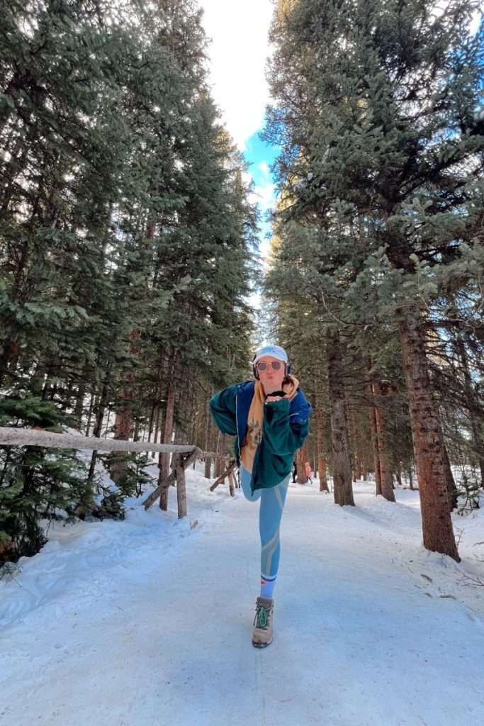 Traveler Liz standing in the forest in Breckenridge