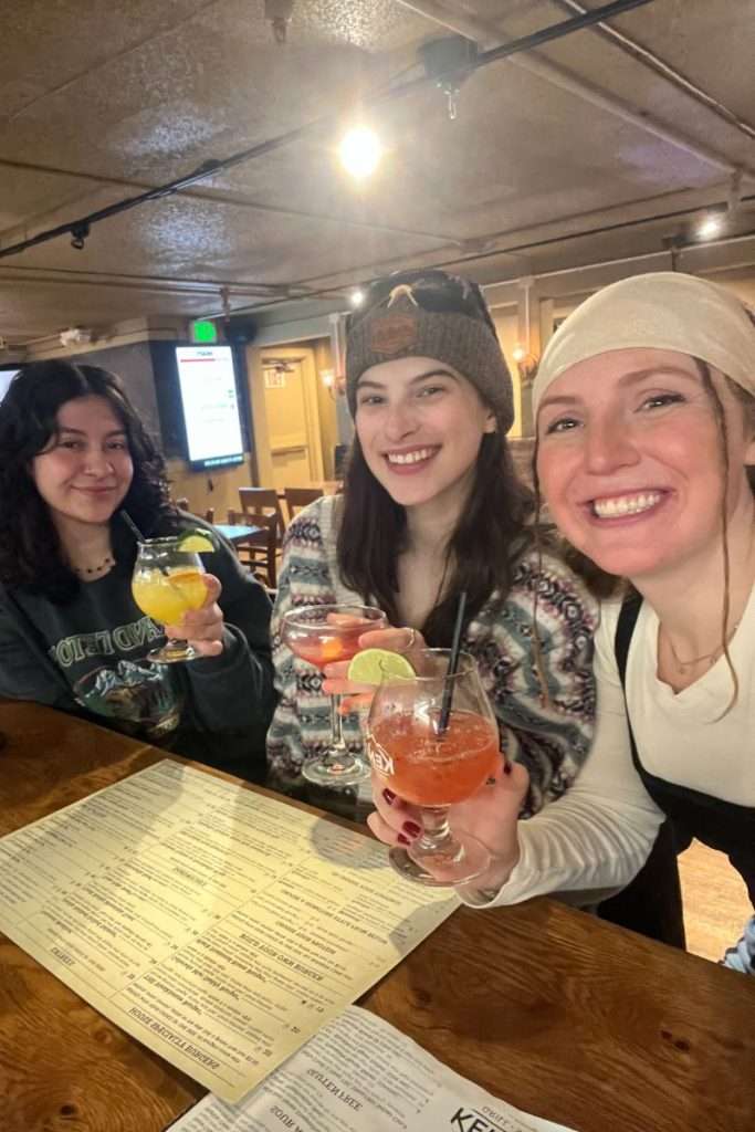 Three friends sitting and drinking at Kenosha Steakhouse