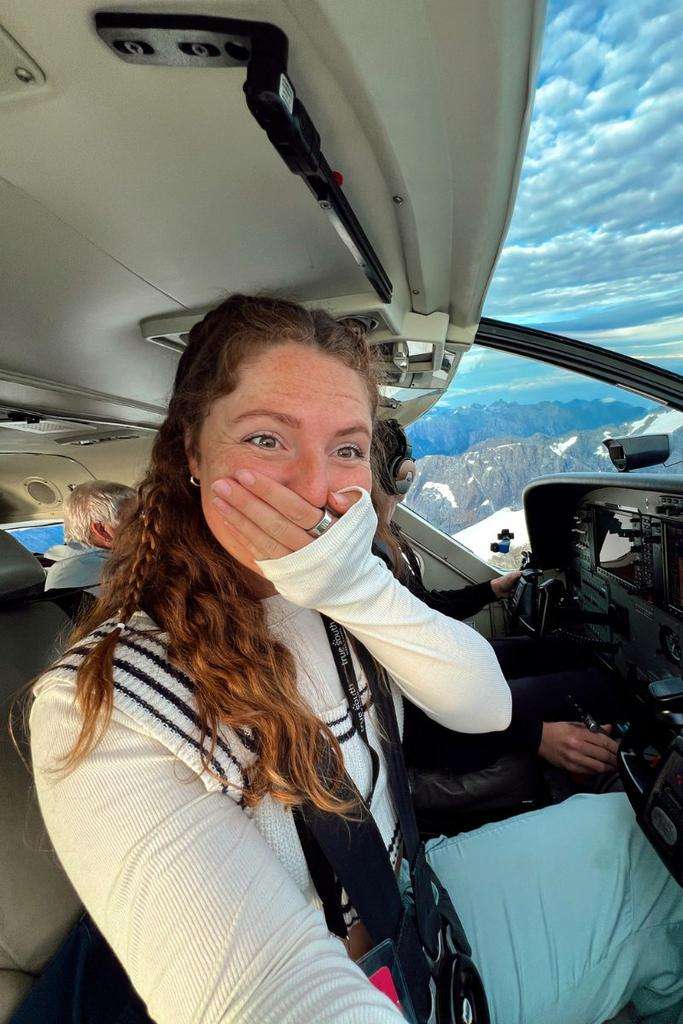 Traveler Liz on a flight over New Zealand, one of the working holiday destinations.