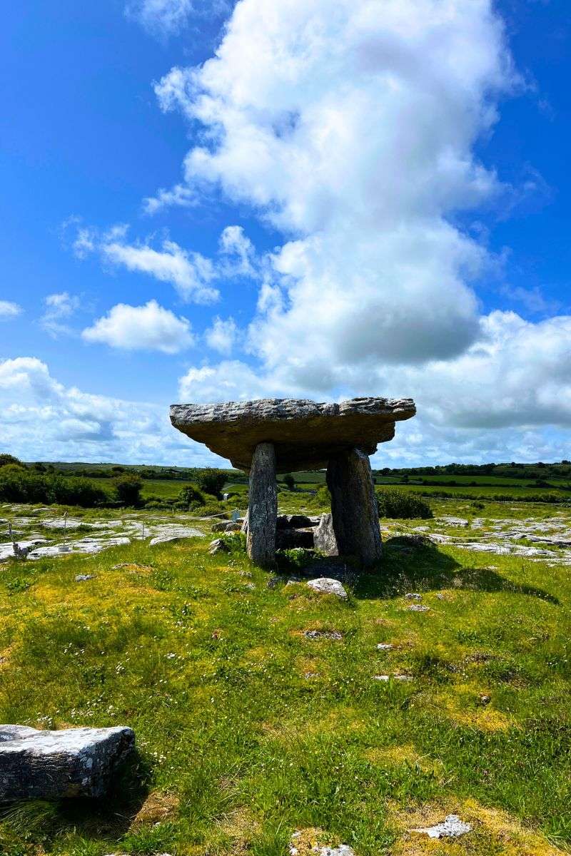 Poulnabrone Dolmen in the Burren Ireland with limestone landscape and blue sky on a day trip from Galway