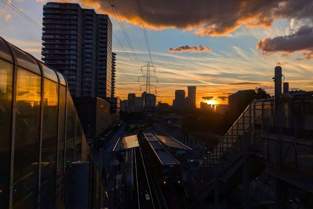 The sun setting behind the train tracks in London