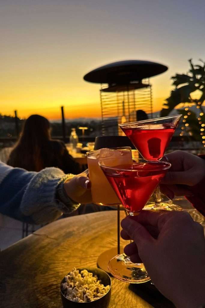 Craft cocktails clinking at sunset in Athens at Attic Urban Rooftop bar