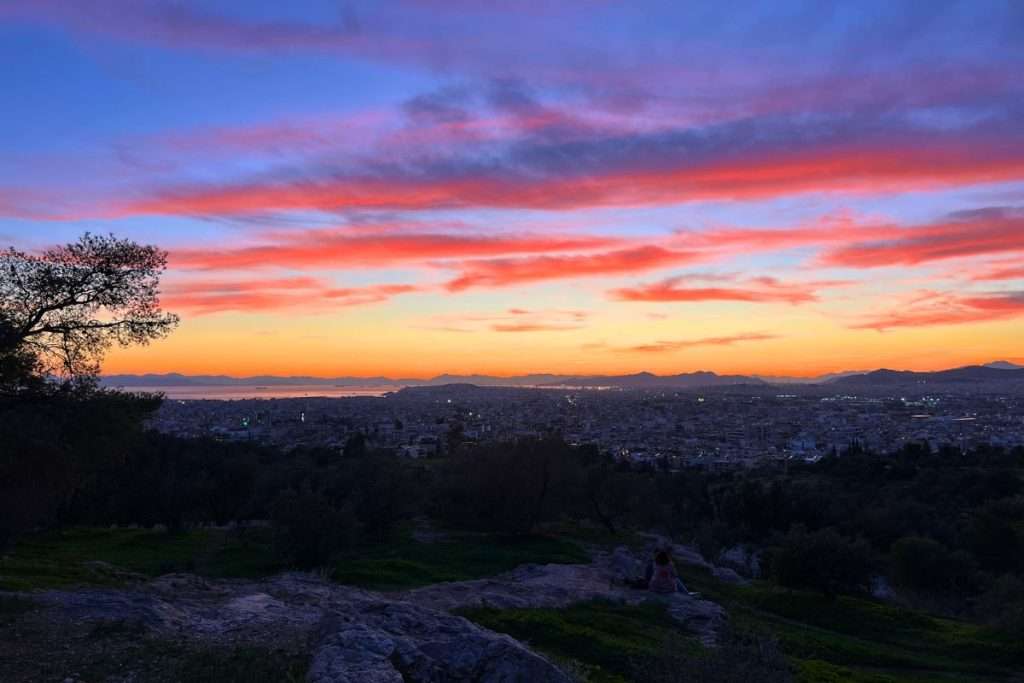 A gorgeous sunset lighting up the whole sky in Athens at Philopappos Hill