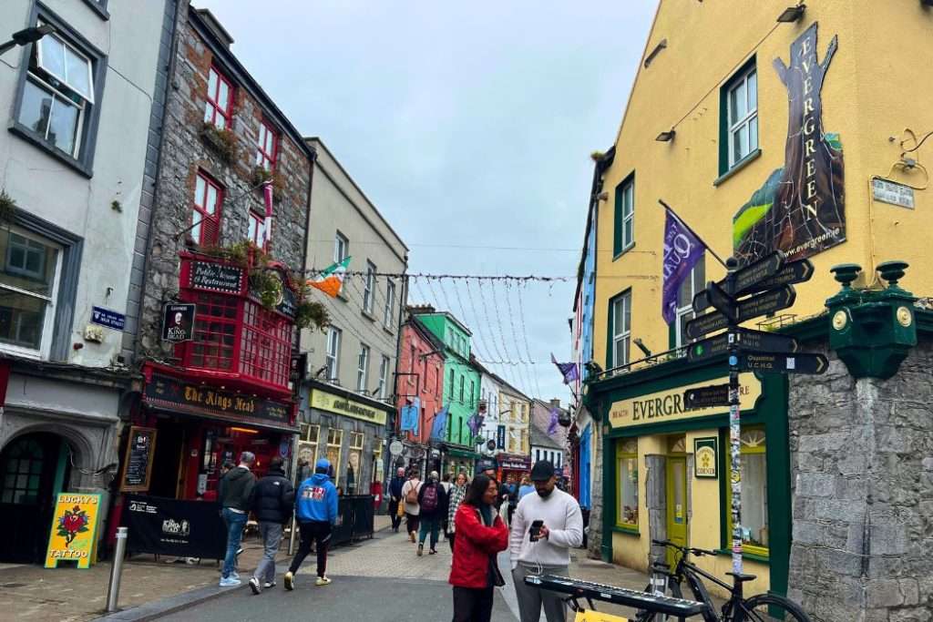 A colorful Irish village street in Galway with traditional pubs.