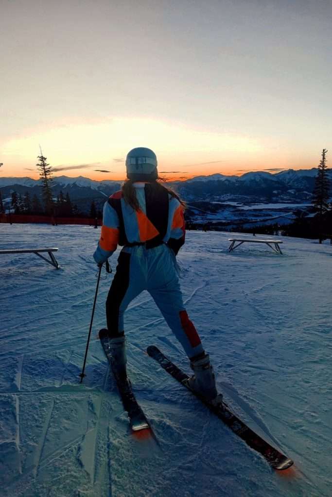 Liz skiing into the sunset in Colorado at Keystone resort while night skiing.