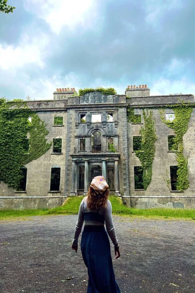 Liz exploring old family ruins on an ancestry tracing journey in Ireland.